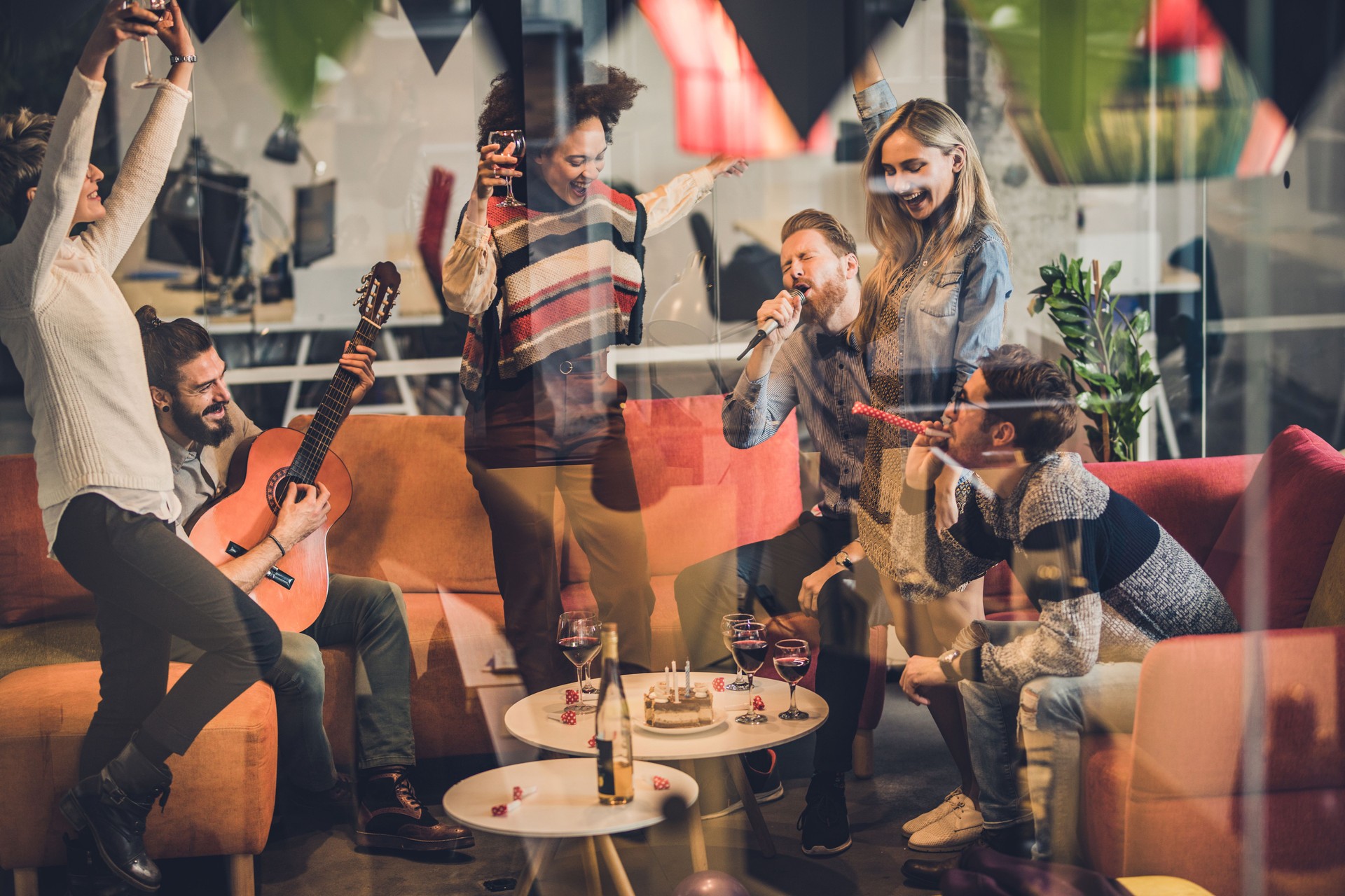 Large group of happy creative people having fun on a party in the office.